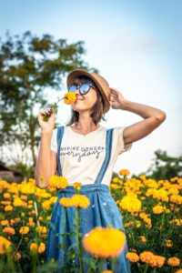 woman smelling calendula flower - crushed vegan aftercare